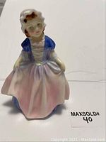 Front view of Royal Doulton figurine in pastel gown with bonnet.