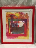Full view of the framed bright abstract silkscreen print with red frame and white matting.