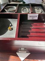 Valet box with compartments holding 3 bracelets and 1 pendant