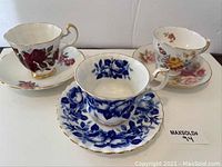 Set of 3 vintage china tea cups and saucers displayed, showing entire lot.