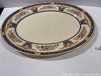 Full view of the vintage Johnson Brothers oval platter showing the floral and blue, gold decor border