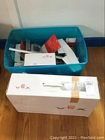 White VEX V5 Robotic Design System box beside blue tote of accessories