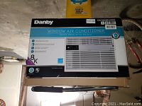 Photo of the boxed Danby window air conditioner showing brand, model number, and cooling capacity 8,000 BTU.