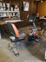Side view of the NordicTrack recumbent exercise bike showing seat, pedals, and console.