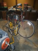 Side view of the entire Raleigh Record CX bicycle showing the frame, wheels, handlebars, and Blackburn rack, taken indoors on concrete floor in basement environment.