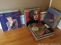 Photo showing vinyl records of Gary Numan, Warren Zevon, and a stack of other records including War Greatest Hits