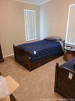 Left side view of assembled bed set with bedding in bedroom