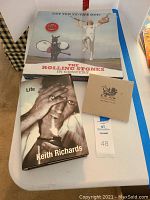 All three items arranged on table: DVD box set, 'Life' book, Wingless Angels CD