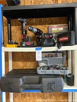 Two cordless drills, one right angle and one traditional, with battery packs and charger, yellow case with drill bits.
