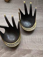 Pair of brass hand dishes showing the front sides with "ISRAEL" inscribed.