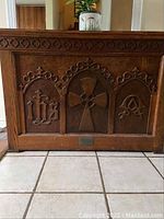 Front view showing carved Gothic arches and church symbols