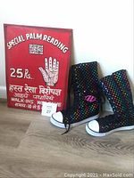 Photo of the colorful Heelys shoes next to the red palm reading sign.