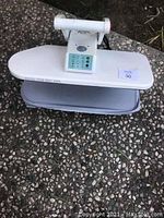 Steam Fast steam press machine showing full unit on ground with cushion base and pressing surface.