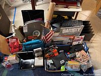 Mixed assortment of items including Star Wars bags, small US flag, binders, and miscellaneous collectibles.