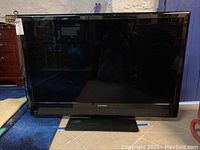 Front view of Mitsubishi 46-inch television showing large flat screen and base stand