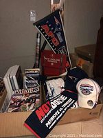 Photo showing Patriots AFC Champions pennant, rally towels, hats with Champions logo, and game day programs and yearbooks.
