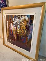 Framed art print leaning against wall showcasing the full artwork and frame