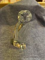 Front view of the clear Baccarat glass owl figurine, showing detailed head and body.