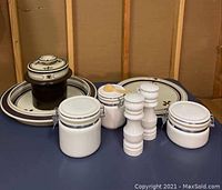 Photo shows full set of Rosenthal stoneware, two large plates, tray, canisters, and salt & pepper shakers arranged on table.