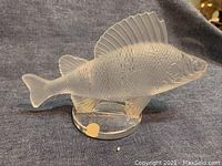 Side view of Lalique frosted crystal fish figurine on clear base