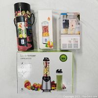 Photo of all three items in their original boxes: La Reveuse blender, wireless juicer cup, and 20-speed fruit juice cup.