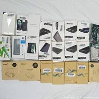 Overview of power banks, solar power banks, and battery phone cases in original packaging, arranged on a white surface.
