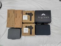 Two Renpho full-body massager boxes, two A9 Pro silhouette boxes, one Aigrous box, two fabric cases