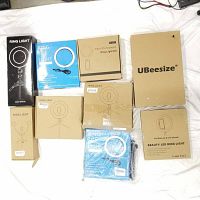 Nine assorted ring lights in original boxes on white background, showing a variety of packaging styles and brands.