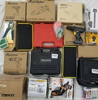 Overview of all boxed items laid out: drills, rotary tools, inspection camera, driver, mask set
