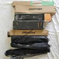 All tripods laid out with their boxes and carrying cases visible