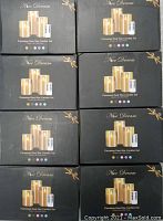 8 black boxes, each containing a Nice Dream Flameless Real Wax Candle Set with remote control several colored dots on front