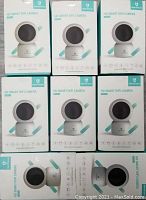 Eight boxed HeimVision HD Smart WiFi Cameras model HM203 arranged in two rows of four