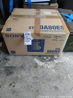 Sony STR-DA80ES stereo receiver box taped closed, labeled as untested with scratches.