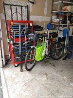 Wide shot of entire lot showing red bike, rack, pump and accessories in garage