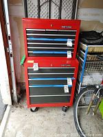 Front view of red Craftsman top chest stacked on bottom roll-away cabinet