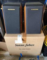 Two Sonus Faber bookshelf speakers on top of original Sonus Faber box