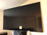 Front view of Samsung 55-inch TV mounted on wall