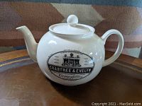 Front side view of the porcelain teapot showing the Crabtree & Evelyn logo and branding