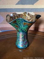 Full view of the iridescent oil spot vase showing fluted ruffled top edge and vibrant colors.