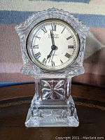 Front view of Godinger Crystal Legends Quartz Desk Clock showing the clock face with Roman numerals and clear crystal cut stand.