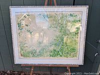 Full view of the framed Japanese woodblock print depicting an overhead view of a boater rowing on a pond with surrounding greenery.