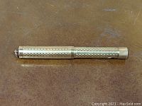 Gold-tone vintage Waterman Ideal pen with gothic overlay detailing shown on tabletop