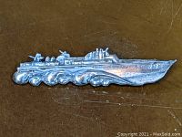 Front view of sterling silver WWII PT boat pin showing intricate details of the boat and waves.