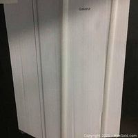 Photo showing the factory sealed box with the brand name Galanz visible on the side of the box.