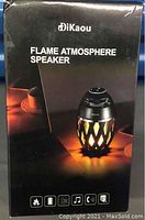 Box front showing DiKaou Flame Atmosphere Speaker branding with image of the speaker lit, black box with icons at bottom.