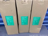 Three boxed Homasy handheld vacuum cleaners standing upright showing product labels.