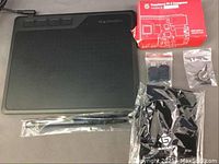 Full lot showing Gaomon graphic tablet, pen, USB cable, power cord, drawing glove, and Raspberry Pi 4 Model B with accessories in retail box