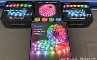 Four boxed LED strip lights from brands Govee and Minger showing packaging and branding.