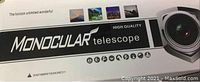 Close-up of the product box showing branding and product type 'Monocular telescope high quality' with warning to not observe the sun directly.