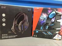 Photo of the two headset boxes side by side, showing B3510 Bluetooth gaming headset box and V-3 Pro Gaming Headset box.